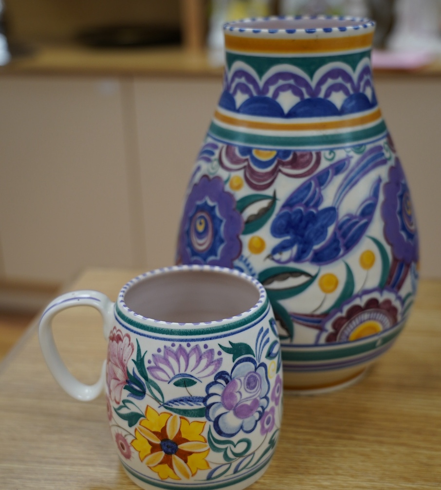 A 1930’s Poole pottery vase and a later mug, vase 25cm high. Condition - fair slight grazing to base rim of vase